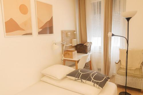 a white room with a chair and a lamp at Le 9 Privé Chambres Chic à Puteaux près Paris, kitchen et 2 SDB ideal couples et Professionnels en déplacement in Puteaux