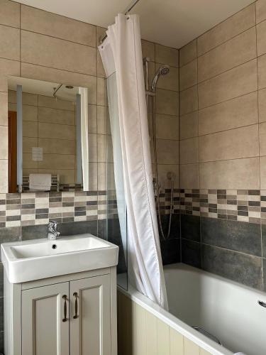 a bathroom with a sink and a tub and a shower at St. Davids Cross Hotel in St. Davids