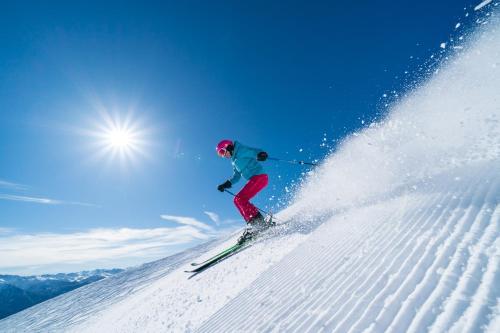 a person is skiing down a snow covered slope at Studio à Vallouise-Pelvoux - Puy Saint Vincent, nature, rando et ski in Vallouise