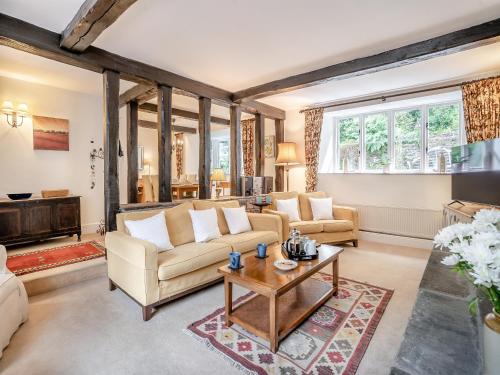 a living room with a couch and a table at The Carriage House in Llanwenarth