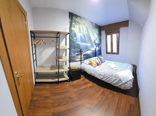 a small room with a bed and a shelf at El Mirador de Tanes in Tanes