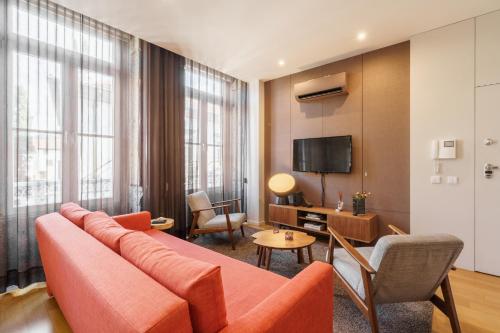 a living room with a couch and a room with a tv at Bracara Home By Minhos Guest in Braga