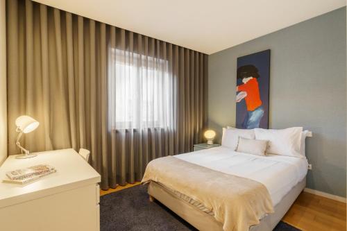 a hotel room with a bed and a window at Bracara Home By Minhos Guest in Braga