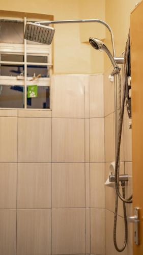 a shower in a bathroom with a window at Zen Escape Nanyuki in Nanyuki