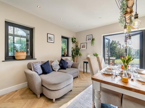 a living room with a couch and a table at Bwythyn Cudd in Manortown