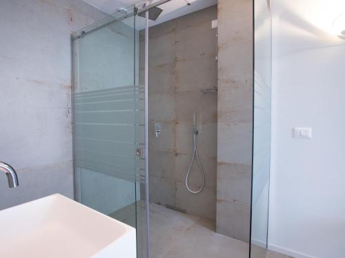 a glass shower in a bathroom with a sink at Roca Du Ma Pasu in Monterosso al Mare