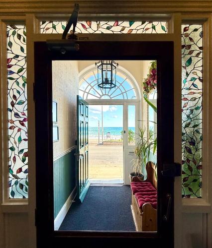 a door to a room with a view of the ocean at The Angove - Adults Only in Weymouth