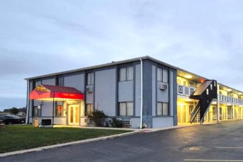 a large building with a sign in front of it at Economy Inn Merrillville By Townhouse I 65 in Merrillville