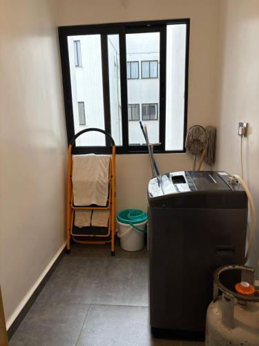 a room with a window and a refrigerator in a room at Tatu city Springs in Tatu City