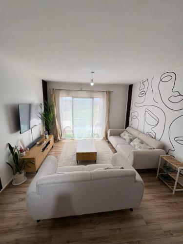 a living room with two couches and a table at Tatu city Springs in Tatu City