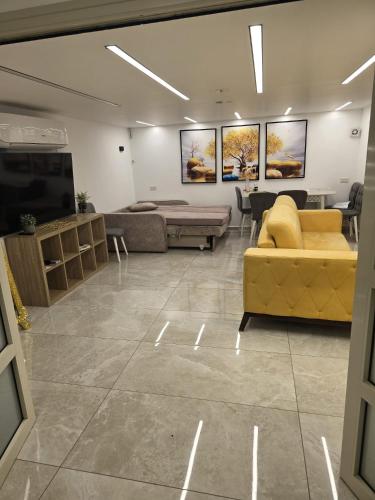a living room with couches and a flat screen tv at Nancy zimr 1 in Massada