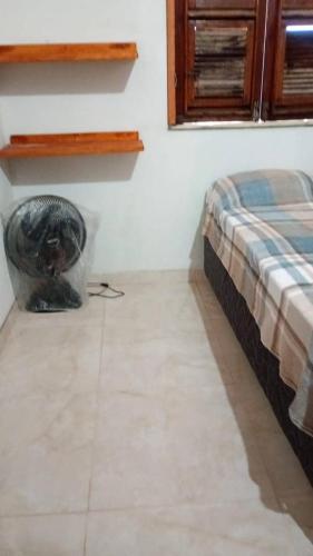 a bedroom with a bed and a tiled floor at Casa por do sol Flecheiras in Flecheiras