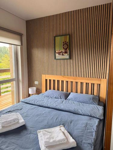 a bedroom with a blue bed with a cat on the wall at Готель Еко-Міївка in Krasnik
