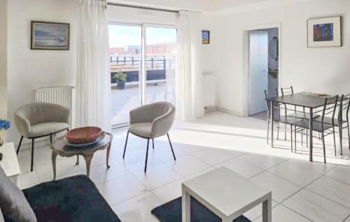 a living room with a couch and chairs and a table at Gorgeous Apartment In Dunkerque With Wifi in Dunkerque