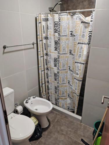 a bathroom with a toilet and a shower curtain at Lo de Estani in La Paz