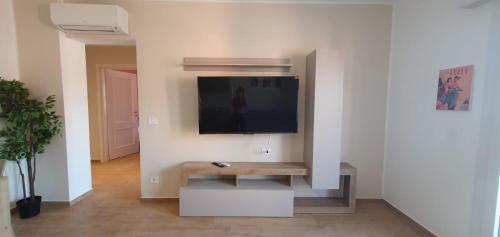 a living room with a flat screen tv on a wall at Casa Tintoretto The Charm of Venice in 15 minutes! in Venice