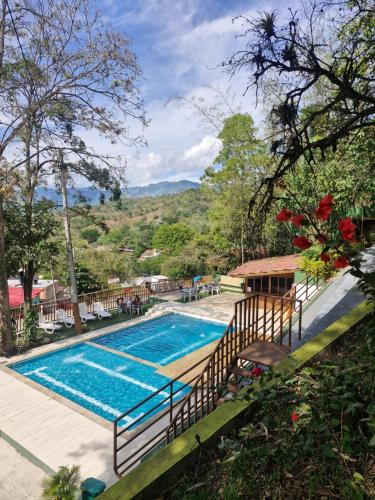 a swimming pool in the middle of a resort at Ecohotel Alflo Inn in Villeta