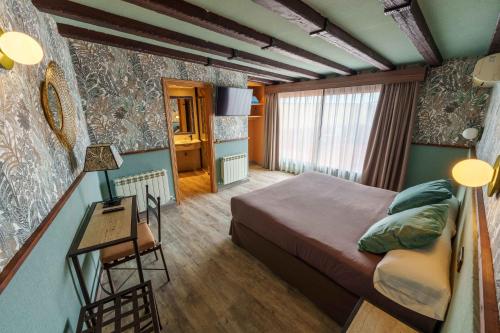 a bedroom with a bed and a table in a room at Hotel Sol in Toledo