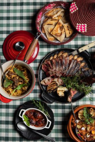 a table with several plates of food on a table at Casa Beatnik Country House in Santiago de Compostela