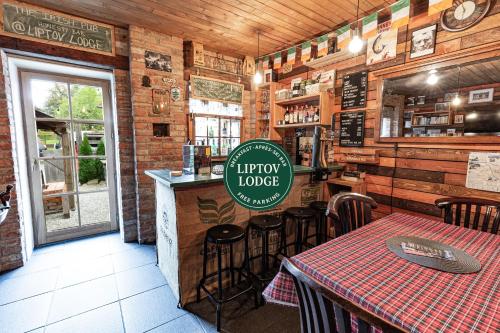 a restaurant with a table and a sign in the middle at Liptov Lodge in Liptovský Mikuláš