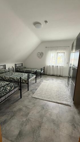 a room with four beds and a window at Adler Haus in Neunkirchen
