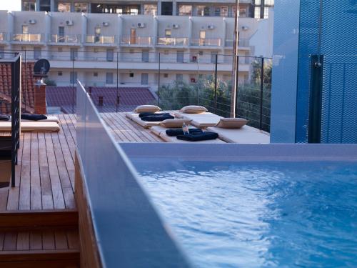 a swimming pool on the roof of a building at Corso Levante Luxury Suites in Petrovac na Moru