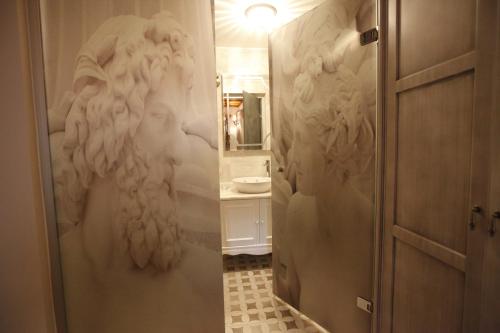 a bathroom with a shower with a white wall at Livia Hotel Ephesus in Selcuk