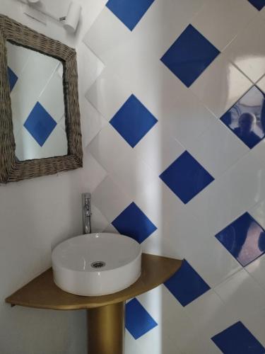 a bathroom with a sink and blue and white tiles at Casa Edelmira Apartment in Vallehermoso