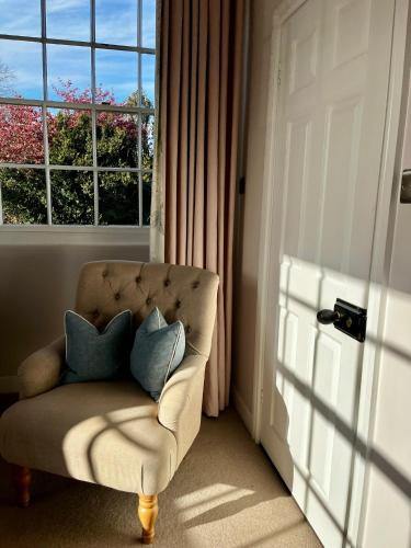 a room with a chair with two pillows on it at The Seagrave Arms in Weston Subedge