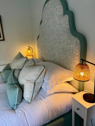 a bed with two lamps and two pillows on it at The Seagrave Arms in Weston Subedge
