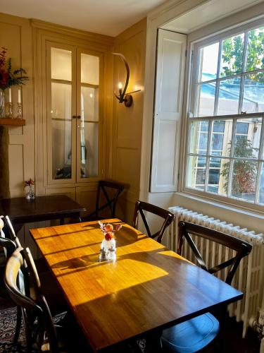 a wooden table in a room with a large window at The Seagrave Arms in Weston Subedge