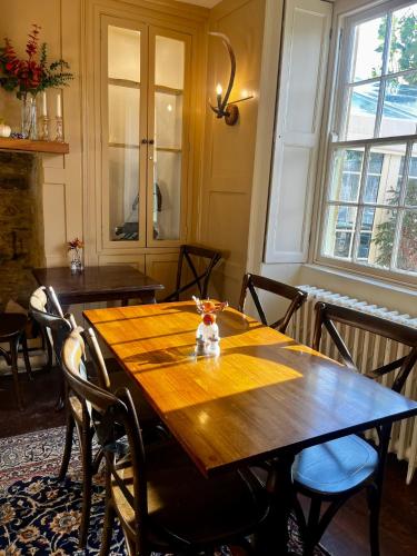 a dining room table with chairs and a wooden table at The Seagrave Arms in Weston Subedge