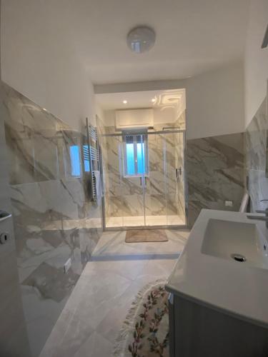 a bathroom with a shower and a sink and a toilet at Sunset Home in Bari