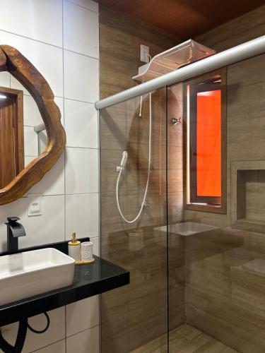 a bathroom with a sink and a shower at Casamares Ipioca Beach Hibiscus Maceió in Maceió