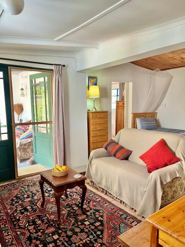 a bedroom with a bed with red pillows on it at 31 on Kloof in Aurora