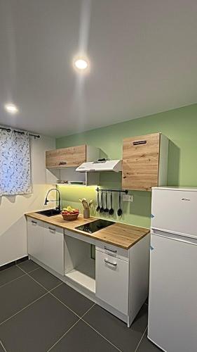 a kitchen with a sink and a refrigerator at Casa Nalya in Kourou