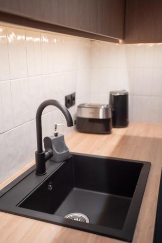 a kitchen counter with a sink and a counter top at Ground Living in Volos