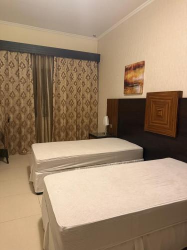 a hotel room with two beds and a window at Hotel B dracula in Bran