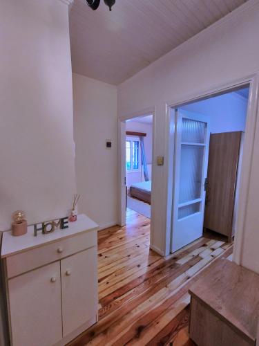 an empty living room with a wooden floor at Citadel's Tranquility Ioannina in Ioannina