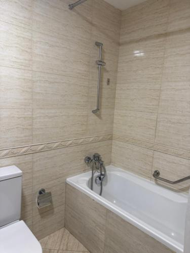 a bathroom with a tub and a toilet at Hotel B dracula in Bran