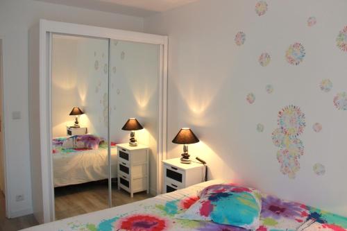 a bedroom with two beds and a mirror at Fun and quiet in Paris