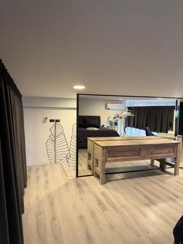 a living room with a table and a mirror at Replay R6 Pool Villa in Bophut