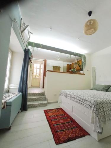 a bedroom with a bed and a rug at Charming Holiday Home in the historic center of Pietrelcina in Pietrelcina