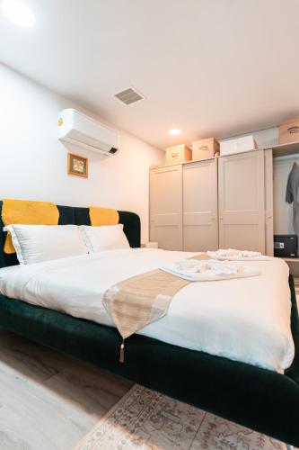 a bedroom with a large bed with white sheets at Replay R6 Pool Villa in Bophut