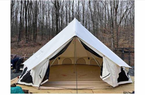 a tent is set up in the woods at Piebald Mountain Pet Friendly Tents, Petersburg, New York in Pownal