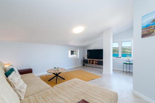 a living room with a couch and a table at Villa Cosy in Trogir