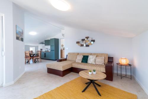 a living room with a couch and a table at Villa Cosy in Trogir