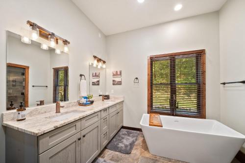 a bathroom with a large tub and a large sink at Cranberry View Lodge in Newland