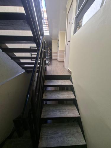 a staircase in a building with wooden steps at Casona Eco Wing in Iquique