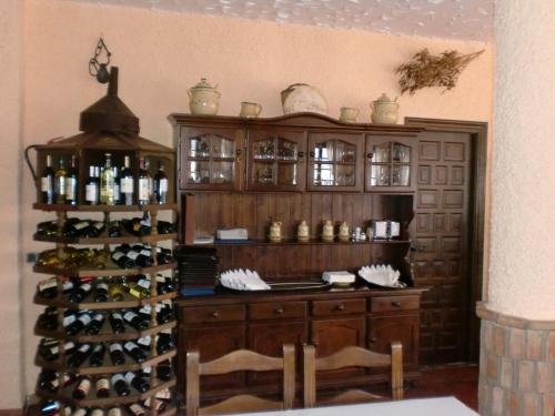 a room with a wine cellar with a bunch of wine bottles at Hotel Restaurante Atalaya in Comares